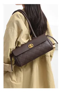 Retro quilted underarm shoulder bag, detailed view of dark brown leather and golden clasp.