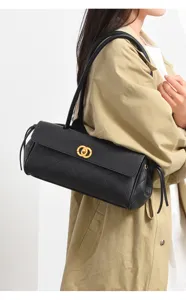 Black leather shoulder bag for women with chic quilted design and elegant gold tone hardware.