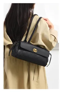 Classic black quilted underarm shoulder bag for women with chic gold clasp and long straps.