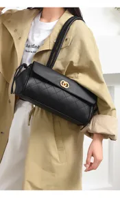 Detailed view of the black quilted leather shoulder bag, showcasing its elegant strap and clasp.