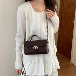 Detailed view of the dark brown quilted chain crossbody bag, elegant lifestyle style.