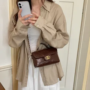 Chic quilted brown shoulder bag with gold hardware, elegant crossbody bag for women daily fashion.