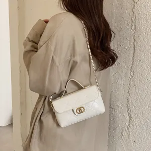 Chic white quilted shoulder bag with chain strap and top handle, elegant daily accessory.