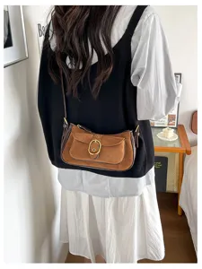 Vintage suede crossbody bag for women, chic patchwork shoulder bag with metal buckle design.