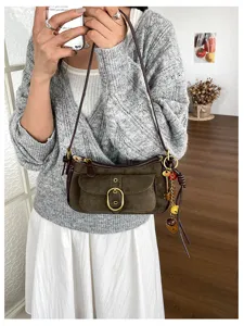 Retro suede crossbody shoulder bag for women with metal buckle and chic pendant charms.