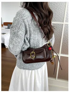 Retro brown shoulder bag detail shot showcasing metal buckle and stylish design for casual daily use.