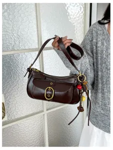 Retro brown underarm shoulder bag with metal buckle and front pocket for women's daily wear.