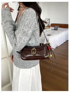 Retro brown shoulder bag for women, stylish PU leather crossbody bag with metal buckle and charms.