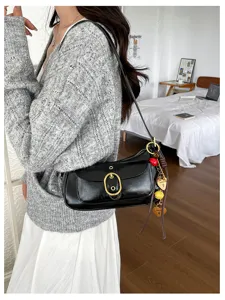 Classic black shoulder bag for women, chic metal buckle design, stylish underarm handbag daily.