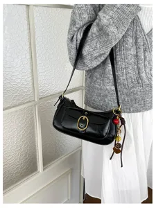 Black chic underarm shoulder bag with metal buckle and charms for women casual daily wear.