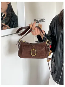 Vintage suede shoulder bag for women, retro brown crossbody bag with metal buckle and chic design details.