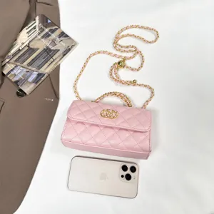 Pink quilted chain shoulder bag with top handle and classic interlocking clasp for women.