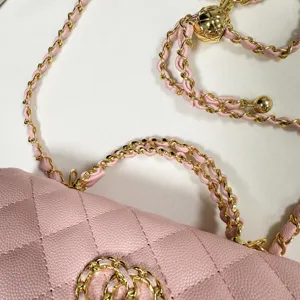 Pink quilted chain shoulder bag detail, stylish fashion crossbody handbag close-up view.
