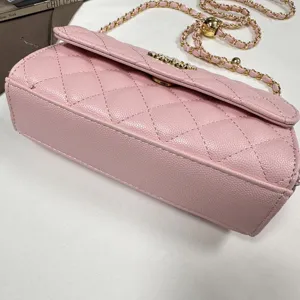 Pink quilted shoulder bag detail close-up showing luxury chain strap and premium textured leather finish.
