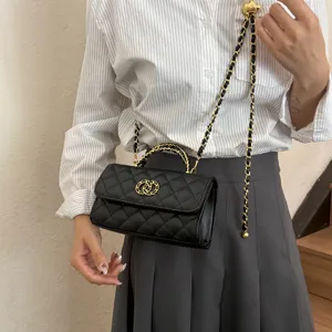 Black quilted shoulder bag with gold chain strap, elegant classic design detail view.