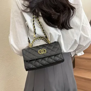 Black quilted shoulder bag with gold chain strap, stylish leather handbag for women detail.