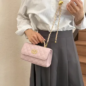 Pink quilted chain handbag for women, elegant shoulder crossbody bag with gold hardware.