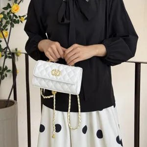 Chic white quilted chain shoulder bag with gold hardware, elegant crossbody handbag for women.