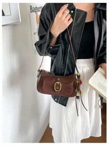 Retro brown suede shoulder bag for women, chic vintage underarm bag with metal buckle design.