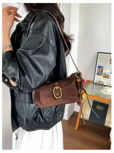 Vintage brown suede shoulder bag for women with metal buckle and chic retro crossbody design.