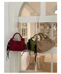 Detail view of retro suede shoulder bag, minimalist pleated dumpling handbag with chic knot.