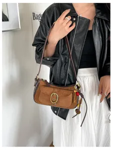 Vintage suede crossbody bag for women, stylish shoulder bag with metal buckle and patchwork.