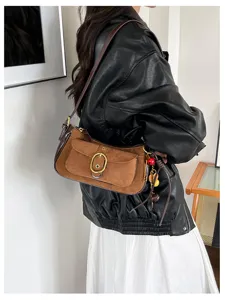 Vintage brown suede shoulder bag for women, chic metal buckle underarm purse with cute charms.