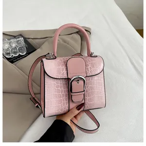 Detailed close-up of the pink crocodile texture retro handbag showing the metal clasp design.