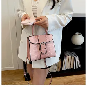 Close-up view of the stylish pink crocodile-pattern handbag, highlighting textured design details.