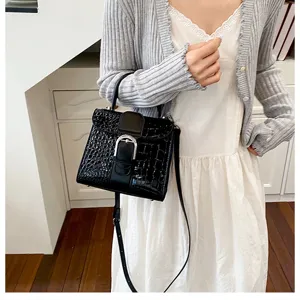 Elegant black crocodile pattern shoulder bag for women, stylish vintage handbag with buckle.