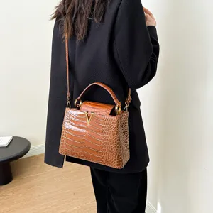 Chic brown crocodile pattern leather shoulder handbag featuring elegant gold hardware details.