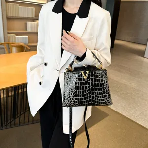 Elegant black crocodile textured leather top handle shoulder bag with golden hardware for women.