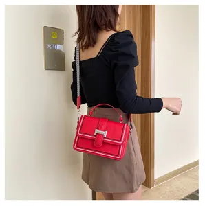 Stylish women crossbody square bag with wide strap and metallic clasp for daily fashion outfit.
