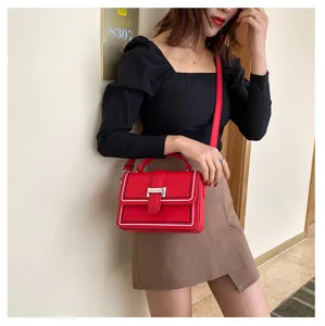 Detailed view of the red crossbody bag for women, featuring chic metal clasp and sleek design.