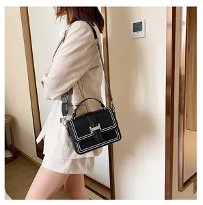 Stylish black leather crossbody bag for women, featuring a top handle and trendy wide shoulder strap.