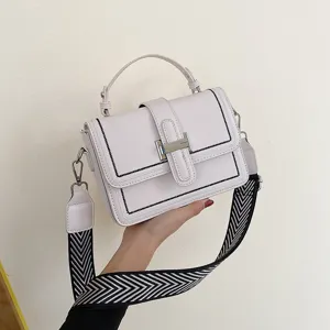 Fashionable white women handbag with statement strap and metallic H-clasp for daily use.