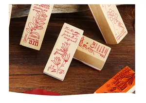 Detailed close-up of retro wooden stamps with botanical patterns and English text for journaling.