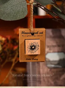 Retro wooden daisy stamp set for journal craft, vintage plant floral design detail view.