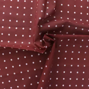 Red and white polka dot cotton fabric detail, French vintage style material for DIY crafts.
