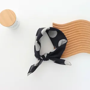 Black and white polka dot scarf, chic French vintage headband for stylish outfit details.