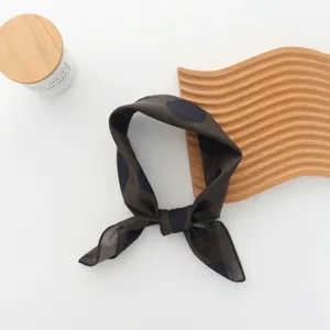 Detailed view of the vintage polka dot scarf, elegant design for chic outdoor styling.