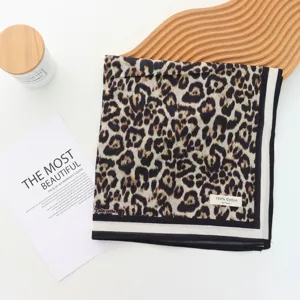Leopard print cotton scarf detail, classic black and white border design, stylish head wrap.