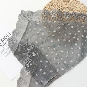 Detailed shot of grey vintage floral lace trim triangular headscarf and delicate border.