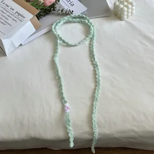 Handmade crochet green ribbon choker necklace detail flat lay stylish accessories