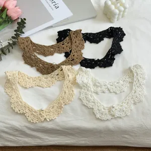 Handmade crochet fake collar detail showing hollow lace and cute pearl button decoration.