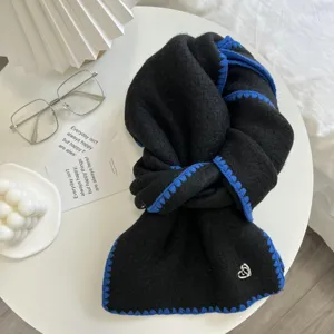 Winter black knit scarf with blue contrast blanket stitch edge and cute heart charm accessory warm