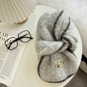 Grey fluffy knitted winter scarf with brown whipstitch edge and cute woven label.