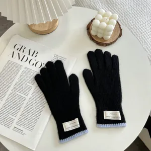 Black knit gloves for women, warm winter gloves with light blue ribbed cuff and label detail.
