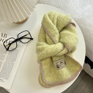 Cozy knit scarf detail shot, featuring soft textured fabric and pink trim for autumn winter.