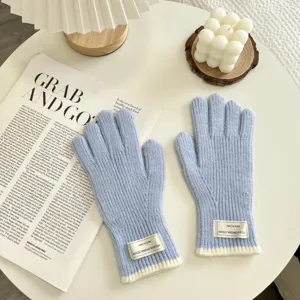 Light blue knit winter gloves with white ribbed cuffs, cozy and stylish daily warm handwear.